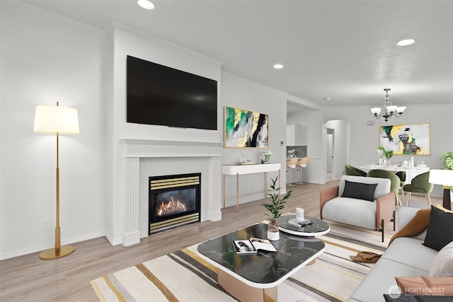 living room with a chandelier and light hardwood / wood-style floors