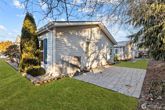 back of house featuring a yard and a patio area