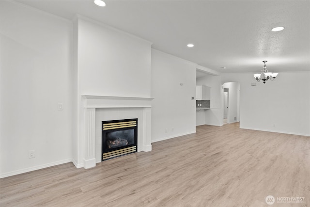 unfurnished living room featuring a tiled fireplace and light wood-type flooring