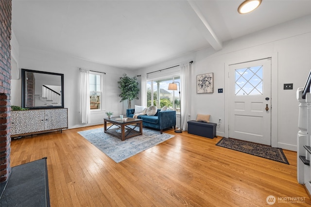 foyer with hardwood / wood-style flooring and beam ceiling