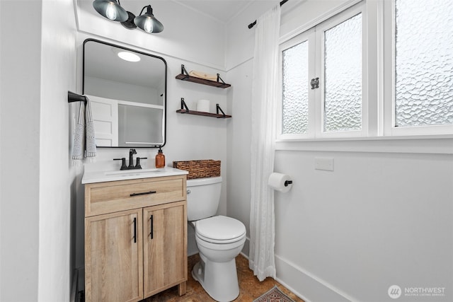 bathroom with toilet and vanity