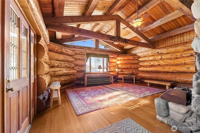 unfurnished room with hardwood / wood-style floors, wooden ceiling, vaulted ceiling with skylight, and a ceiling fan