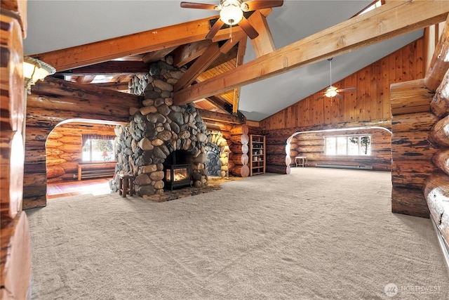 unfurnished living room with beamed ceiling, carpet, a wood stove, and high vaulted ceiling