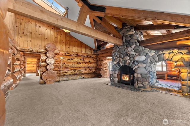 unfurnished living room featuring beamed ceiling, carpet, and log walls