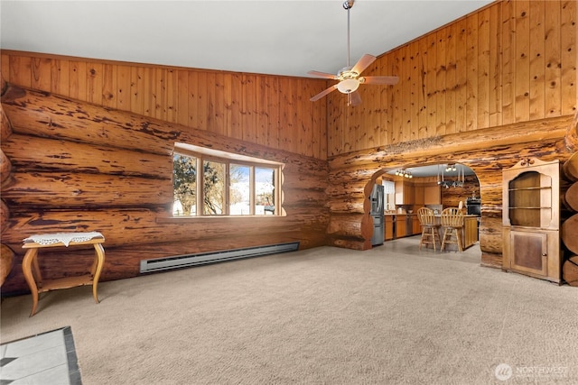 unfurnished room with baseboard heating, rustic walls, arched walkways, high vaulted ceiling, and a ceiling fan