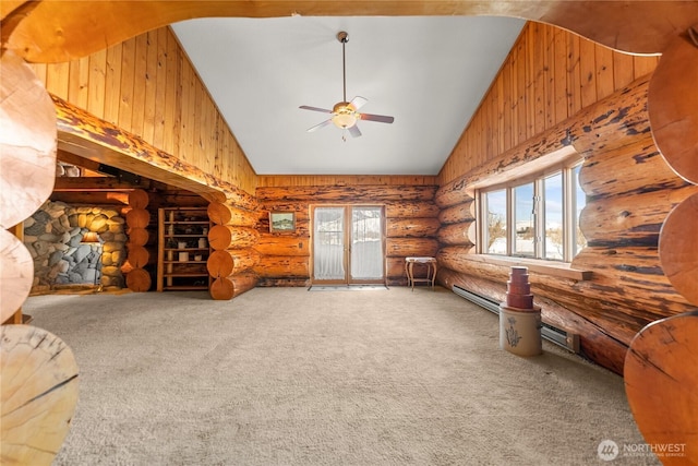 carpeted living area with log walls, a healthy amount of sunlight, and high vaulted ceiling