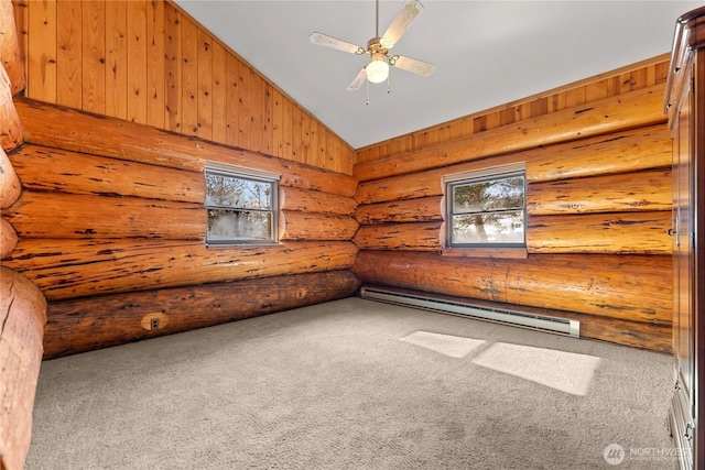 spare room featuring a baseboard heating unit, ceiling fan, vaulted ceiling, carpet flooring, and rustic walls