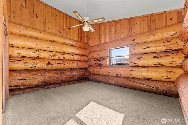 spare room with carpet flooring and a ceiling fan