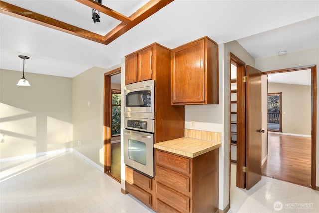 kitchen featuring appliances with stainless steel finishes and decorative light fixtures