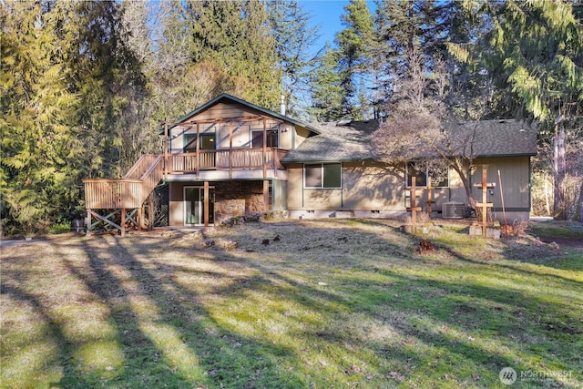 back of house featuring a deck, cooling unit, and a lawn