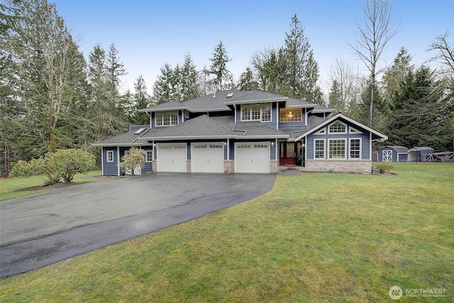 view of front of home featuring a front yard, brick siding, driveway, and an attached garage