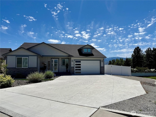 2764 N Breckenridge Dr, East Wenatchee, WA 98802 - view of front of property featuring stone siding, driveway, a garage, and board and batten siding