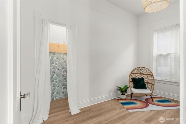 living area featuring baseboards and wood finished floors