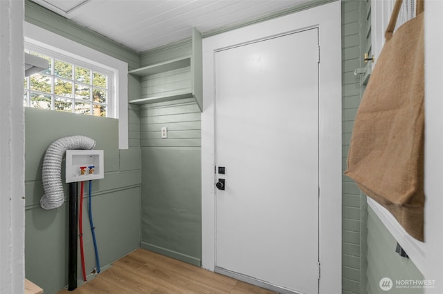 laundry area with laundry area, hookup for a washing machine, and light wood-style floors