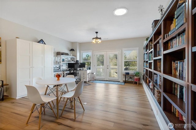 dining room featuring french doors and light wood-type flooring