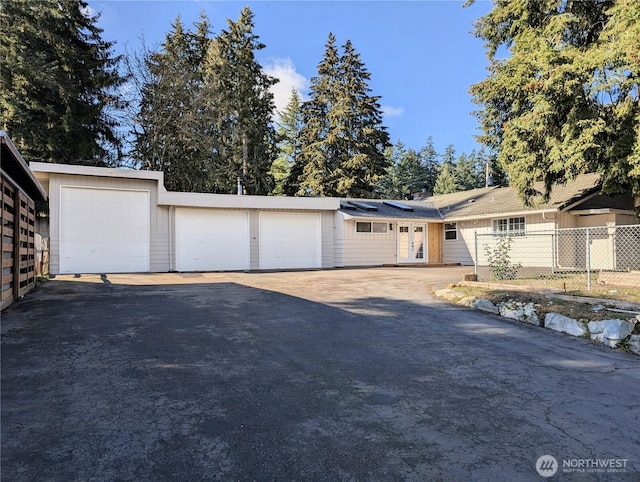 ranch-style home featuring fence