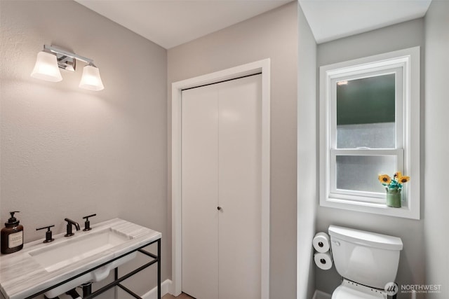 bathroom featuring sink and toilet