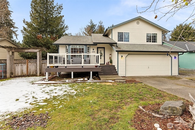 split level home with a garage and a front lawn