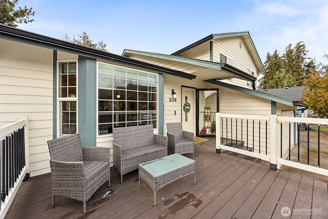 wooden terrace with an outdoor hangout area