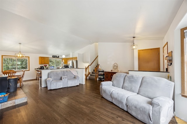 living room with dark hardwood / wood-style flooring and vaulted ceiling