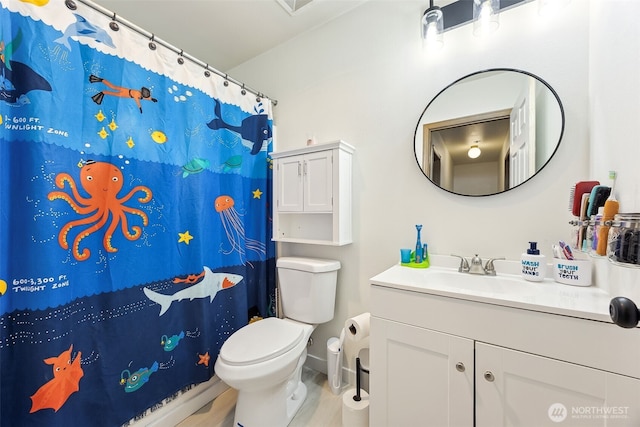 bathroom featuring vanity and toilet