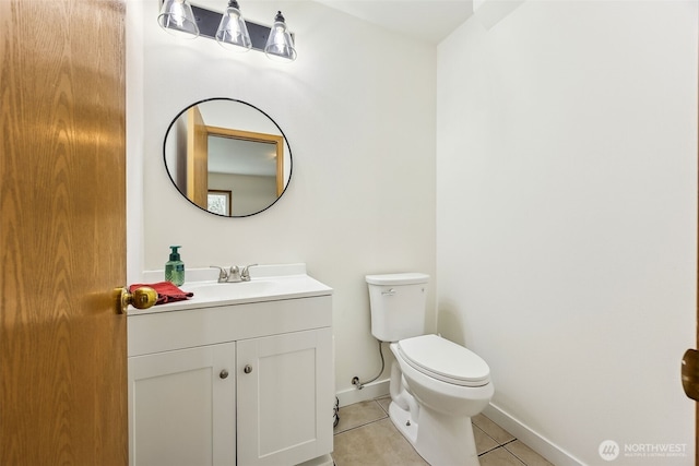 bathroom featuring vanity, tile patterned floors, and toilet