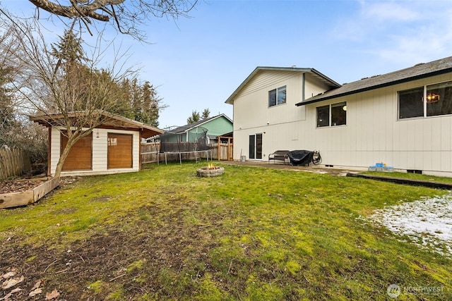 view of yard featuring a fire pit and a storage shed