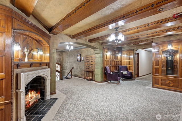 carpeted living room with beam ceiling