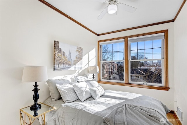 bedroom with ceiling fan and crown molding