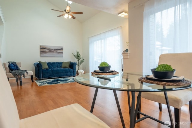 living room featuring ceiling fan, high vaulted ceiling, and hardwood / wood-style floors