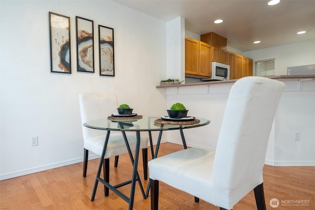 dining area featuring light wood-type flooring