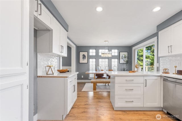 kitchen featuring dishwasher and white cabinets