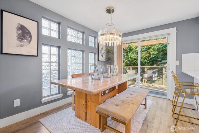 dining room with an inviting chandelier and light hardwood / wood-style flooring