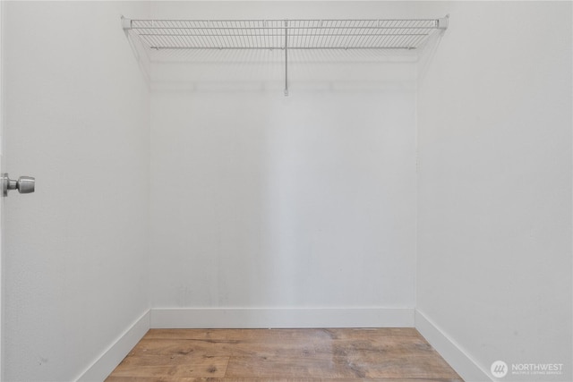 spacious closet featuring hardwood / wood-style flooring