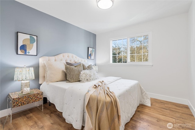 bedroom with hardwood / wood-style flooring