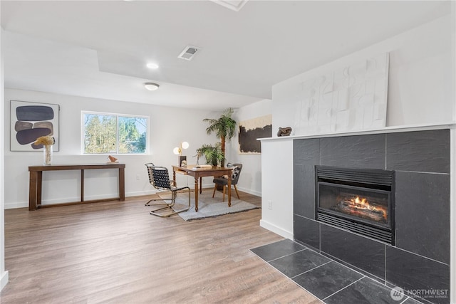 interior space with dark hardwood / wood-style flooring and a tile fireplace