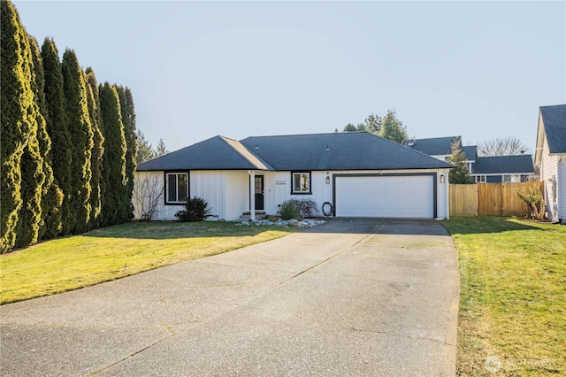 single story home with a garage and a front lawn