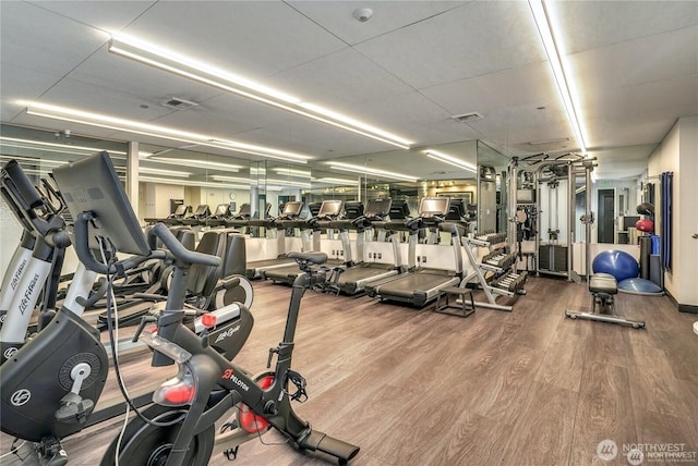 workout area with wood-type flooring