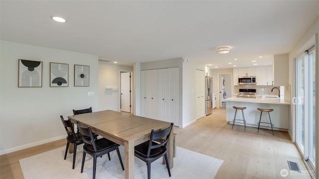 dining area with recessed lighting, visible vents, baseboards, and light wood-style floors