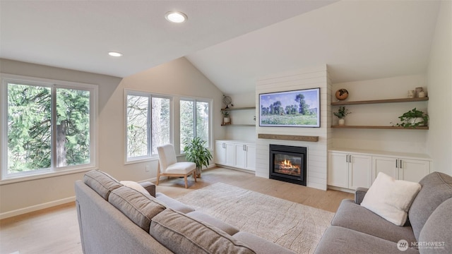 living room with recessed lighting, baseboards, a large fireplace, light wood-style floors, and lofted ceiling