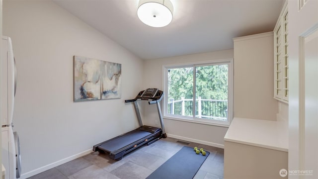 workout room with lofted ceiling, baseboards, and visible vents