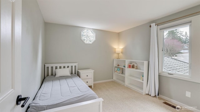 bedroom with carpet, visible vents, and baseboards