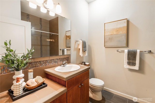 full bathroom with toilet, decorative backsplash, a tile shower, vanity, and tile patterned flooring