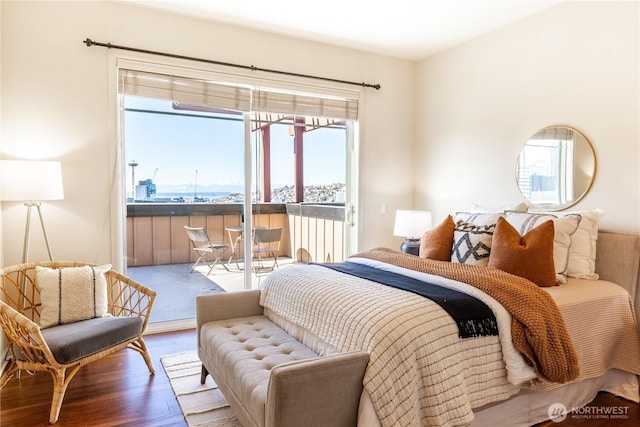 bedroom with access to outside and wood finished floors