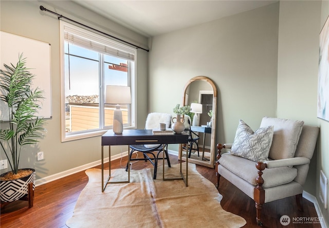 office space featuring baseboards and wood finished floors