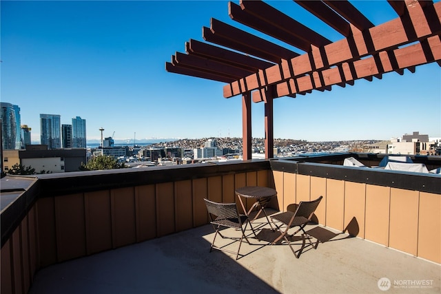 balcony with a view of city and a pergola