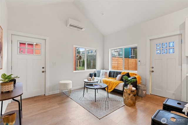 interior space featuring hardwood / wood-style flooring, high vaulted ceiling, and a wall unit AC