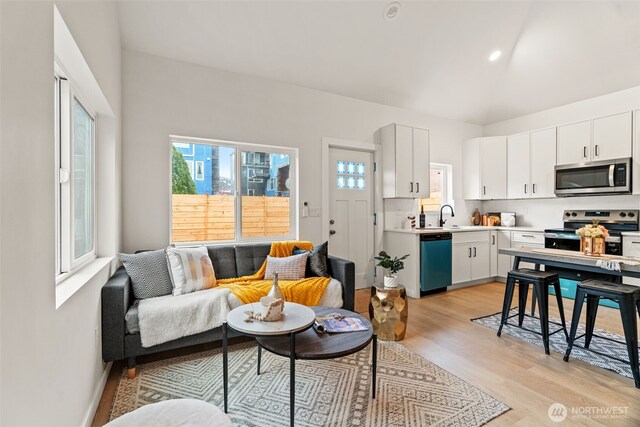 living room with sink and light hardwood / wood-style flooring