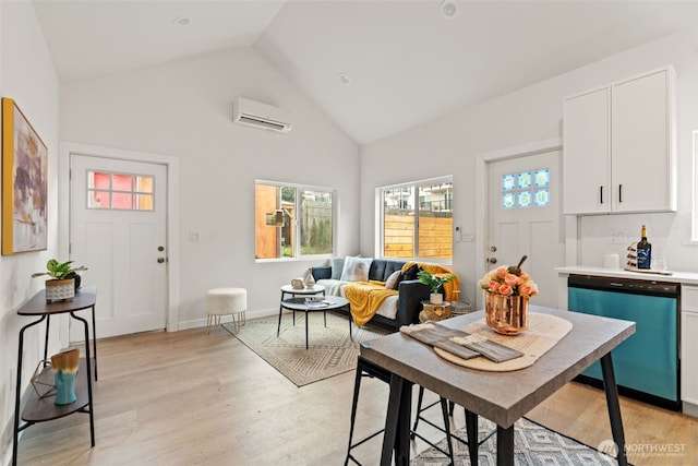 dining area with high vaulted ceiling, a wall mounted AC, and light wood-type flooring