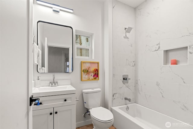 full bathroom with vanity, tiled shower / bath combo, and toilet